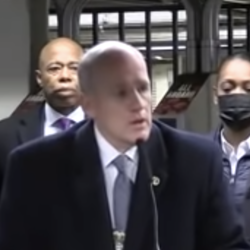 Jason Wilcox pictured with Mayor Adams at a Jan. 15 press conference after a fatal pushing subway incident 