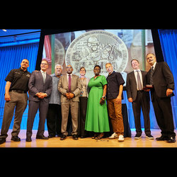 At the 9/11 Museum, Local 100 President Richard Davis (center, with tie) stands with 9/11 Museum CEO Beth Hillman and CED VP Shirley Martin. Next to Davis is former President Tony Utano. At right is NYCT President Richard Davey.