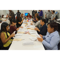 Workers at the American Aribtration Association open ballot envelopes on February 14 in preparation for scanning vote totals