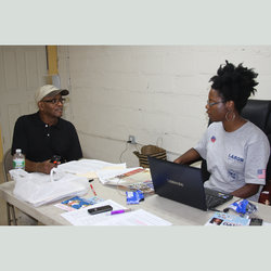 Michele Gilliam with CED volunteer Ben Merrill working the phones