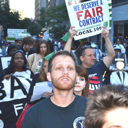 Safety Director for Subways Tom Carrano marches with the OWS crowd holding a Union sign