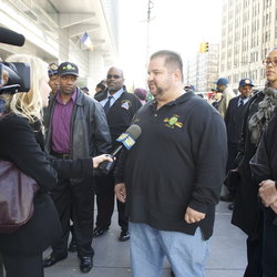 Local 100 President John Samuelsen talks about the assault on Marlene Bien-Aime as Union members look on.