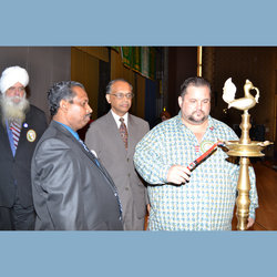 As Local 100 VP Kevin Harrington, Exec Board Member Jolly Eapen, and George Abraham look on, Local 100 President John Samuelsen lights the ceremonial torch at Indian Day