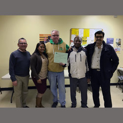 Local 100 Director of Organizing Frank McCann (center) stands with STA and School Bus Division Officers including Orlando Vasquez, Jemary Pabon, Jamille Aine, and Division Chair Gus Moghrabi.