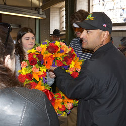 Danny's youngest daughter, Valerie, receives a wreath honoring her late father from Track Division Chairman Paul Navarro