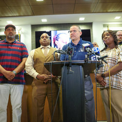Flanked by Station VP Robert Kelley, and Div. Chair Nicolette Browne, Pres. Chiarello addresses the media on the assault against a Station Agent. Behind them is her image on a monitor.
